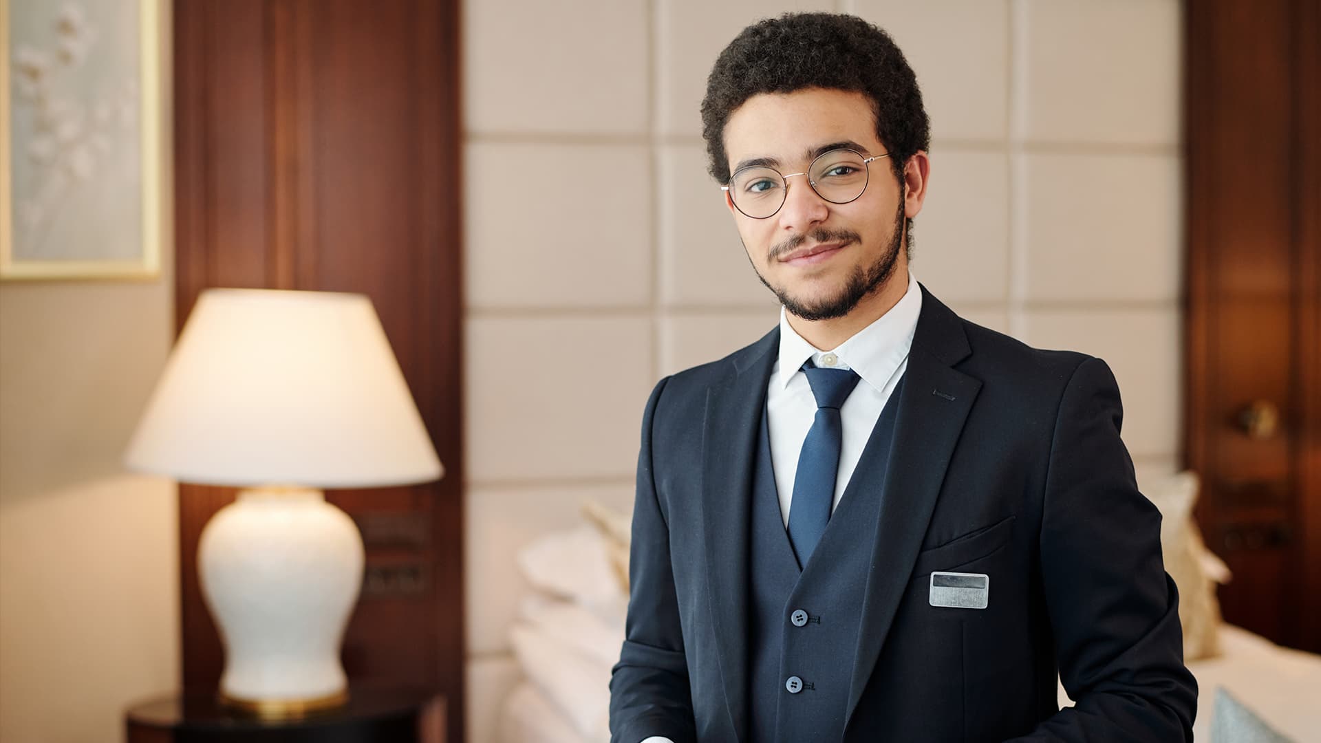 Confident young hotel manager smiling.